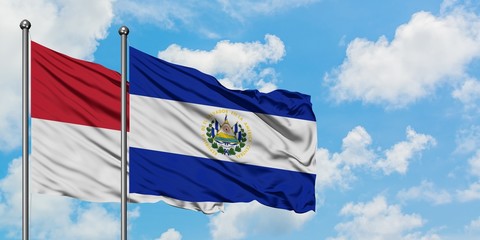 Iraq and El Salvador flag waving in the wind against white cloudy blue sky together. Diplomacy concept, international relations.