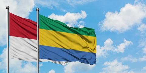 Iraq and Gabon flag waving in the wind against white cloudy blue sky together. Diplomacy concept, international relations.