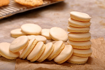Crunchy cookies with icing, closeup of cakes in the bakery