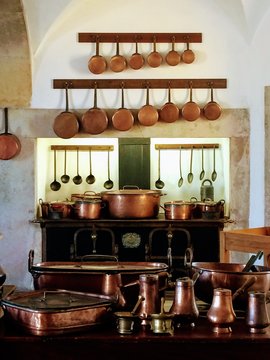 Brass-colored-and-black cooking pots and pans set