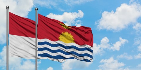 Iraq and Kiribati flag waving in the wind against white cloudy blue sky together. Diplomacy concept, international relations.