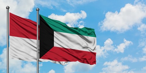 Iraq and Kuwait flag waving in the wind against white cloudy blue sky together. Diplomacy concept, international relations.