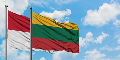 Iraq and Lithuania flag waving in the wind against white cloudy blue sky together. Diplomacy concept, international relations.