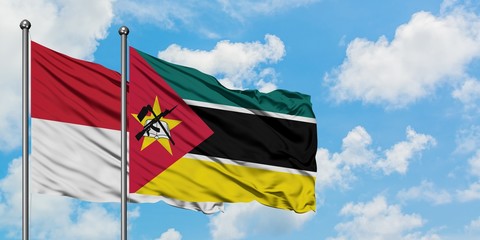 Iraq and Mozambique flag waving in the wind against white cloudy blue sky together. Diplomacy concept, international relations.