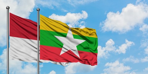 Iraq and Myanmar flag waving in the wind against white cloudy blue sky together. Diplomacy concept, international relations.