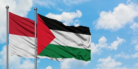 Iraq and Palestine flag waving in the wind against white cloudy blue sky together. Diplomacy concept, international relations.