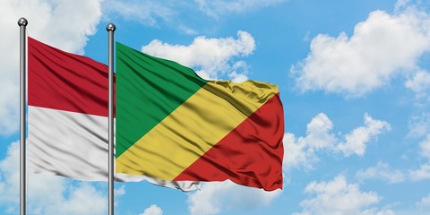 Iraq and Republic Of The Congo flag waving in the wind against white cloudy blue sky together....