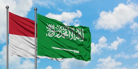 Iraq and Saudi Arabia flag waving in the wind against white cloudy blue sky together. Diplomacy concept, international relations.