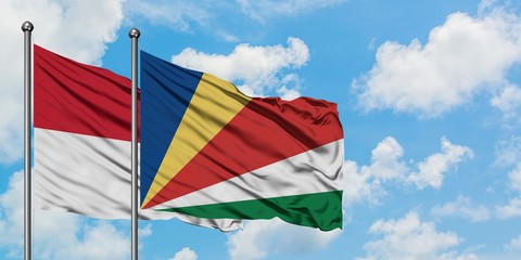Iraq and Seychelles flag waving in the wind against white cloudy blue sky together. Diplomacy concept, international relations.
