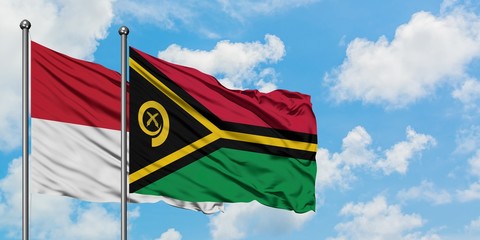 Iraq and Vanuatu flag waving in the wind against white cloudy blue sky together. Diplomacy concept, international relations.