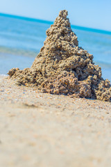 A Childs sand castle waiting for the ocean tide to come in to reclaim it