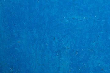 The texture of an old concrete wall painted blue