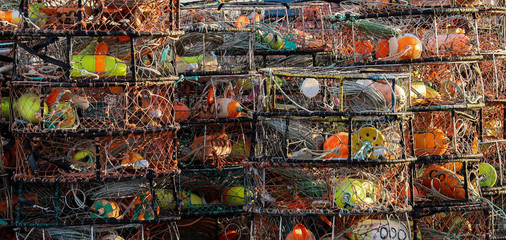 A stack of crab traps loaded with colorful buoys and line sit waiting for the beginning of crab season