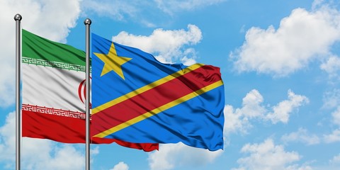 Iran and Congo flag waving in the wind against white cloudy blue sky together. Diplomacy concept, international relations.