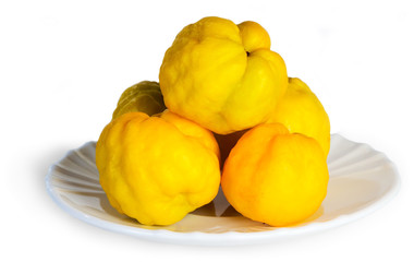 group of quince on a white background in a saucer