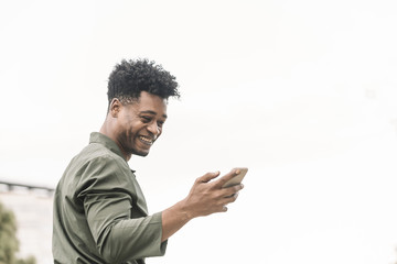 cool african man texting and looking the phone