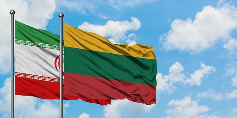 Iran and Lithuania flag waving in the wind against white cloudy blue sky together. Diplomacy concept, international relations.