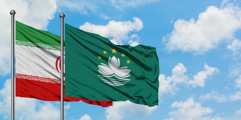 Iran and Macao flag waving in the wind against white cloudy blue sky together. Diplomacy concept, international relations.