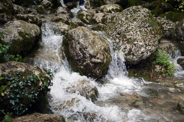 Naklejka na ściany i meble Waterfall in rocks stream