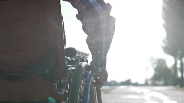 A man in a wheelchair walks on the waterfront