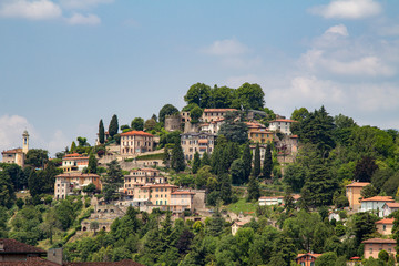 Fototapeta na wymiar Beautiful buildings on the hills. Bergamo. Beautiful, panoramic view. Journey to Italy. Green Summer Landscape. 