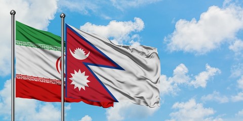 Iran and Nepal flag waving in the wind against white cloudy blue sky together. Diplomacy concept, international relations.