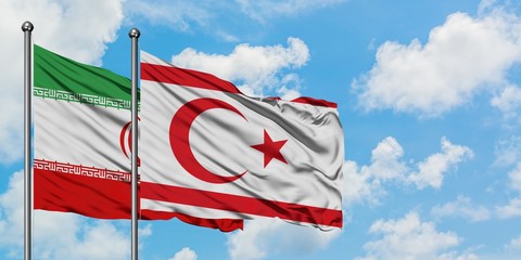Iran and Northern Cyprus flag waving in the wind against white cloudy blue sky together. Diplomacy concept, international relations.
