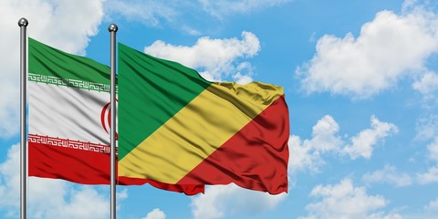 Iran and Republic Of The Congo flag waving in the wind against white cloudy blue sky together. Diplomacy concept, international relations.