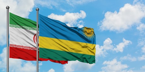 Iran and Rwanda flag waving in the wind against white cloudy blue sky together. Diplomacy concept, international relations.