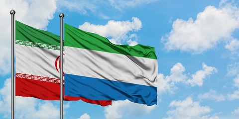 Iran and Sierra Leone flag waving in the wind against white cloudy blue sky together. Diplomacy concept, international relations.