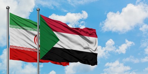 Fototapeta na wymiar Iran and Sudan flag waving in the wind against white cloudy blue sky together. Diplomacy concept, international relations.