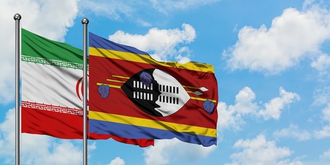 Iran and Swaziland flag waving in the wind against white cloudy blue sky together. Diplomacy concept, international relations.