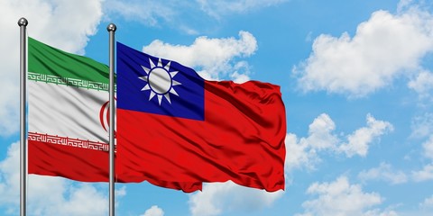 Iran and Taiwan flag waving in the wind against white cloudy blue sky together. Diplomacy concept, international relations.