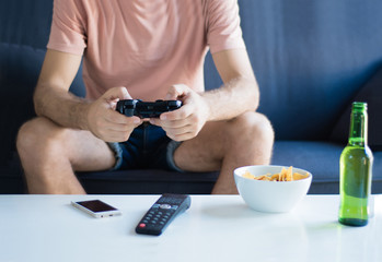 Fototapeta na wymiar Young man playing video games at home.