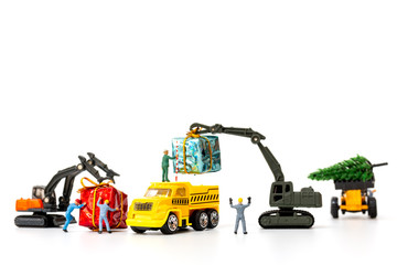 Miniature people working on a gift box