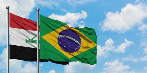 Iraq and Brazil flag waving in the wind against white cloudy blue sky together. Diplomacy concept, international relations.