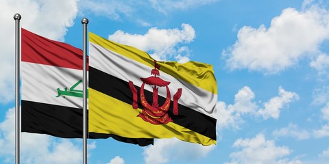 Iraq and Brunei flag waving in the wind against white cloudy blue sky together. Diplomacy concept, international relations.