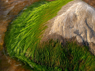 landscape with beautiful rocks by the sea, colorful reflections in the water