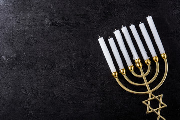 Jewish Hanukkah menorah on black background. Copy space	