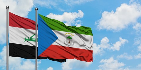 Iraq and Equatorial Guinea flag waving in the wind against white cloudy blue sky together. Diplomacy concept, international relations.
