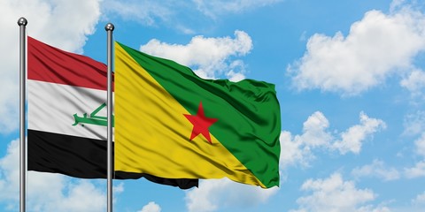Iraq and French Guiana flag waving in the wind against white cloudy blue sky together. Diplomacy concept, international relations.