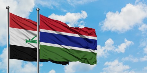 Iraq and Gambia flag waving in the wind against white cloudy blue sky together. Diplomacy concept, international relations.