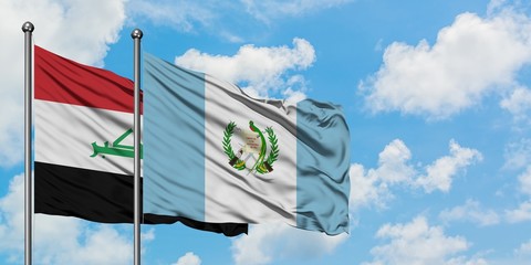 Iraq and Guatemala flag waving in the wind against white cloudy blue sky together. Diplomacy concept, international relations.