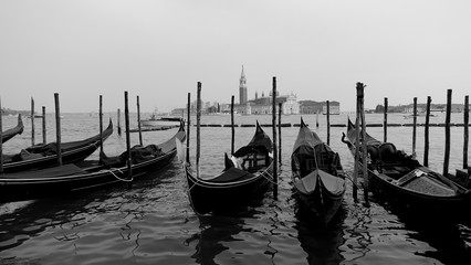 Black and white photo of gondola and gondolier taken in the beautiful city of Venice, Italy © dragomirescu