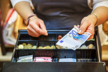 woman is paying In cash with euro banknotes - obrazy, fototapety, plakaty