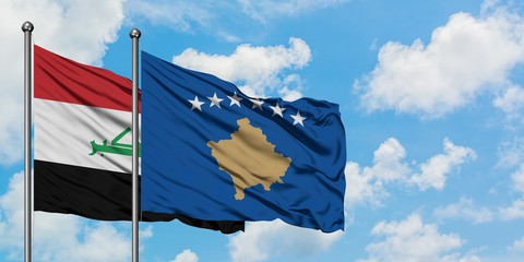 Iraq and Kosovo flag waving in the wind against white cloudy blue sky together. Diplomacy concept, international relations.