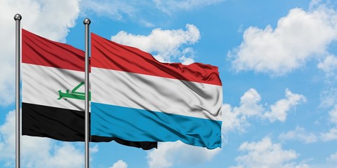 Iraq and Luxembourg flag waving in the wind against white cloudy blue sky together. Diplomacy concept, international relations.