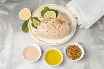Chicken fillet with mustard and sauces. Proper nutrition. On a gray background. Diet meat