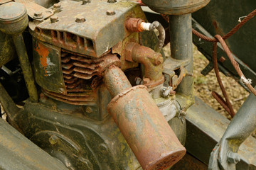 Old abandoned rusty tractor engine.