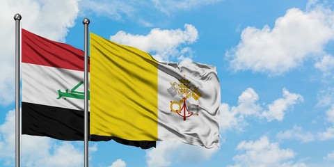 Iraq and Vatican City flag waving in the wind against white cloudy blue sky together. Diplomacy concept, international relations.